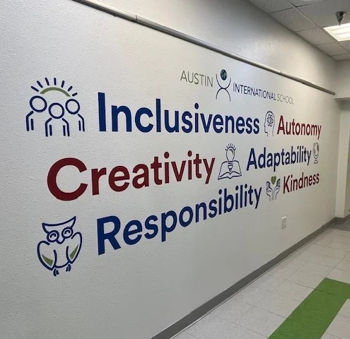 Hallway wall at Austin International School listing its values: inclusiveness, autonomy, creativity, adaptability, responsibility and kindness